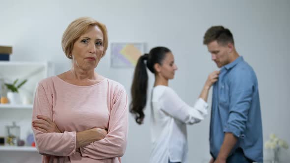 Mother-In-Law With Hands Crossed Disapproving Young Couple Relations, Loneliness