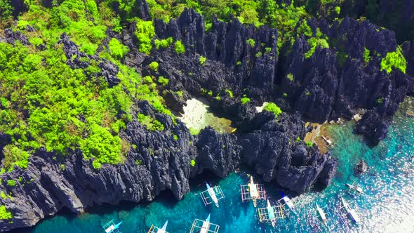 Aerial Drone View of Swimmers Inside a Tiny Hidden Tropical Lagoon Surrounded By Cliffs - Secret