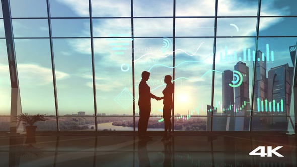 Silhouettes Of People Shaking Hands On A Sunset Background 4K alt