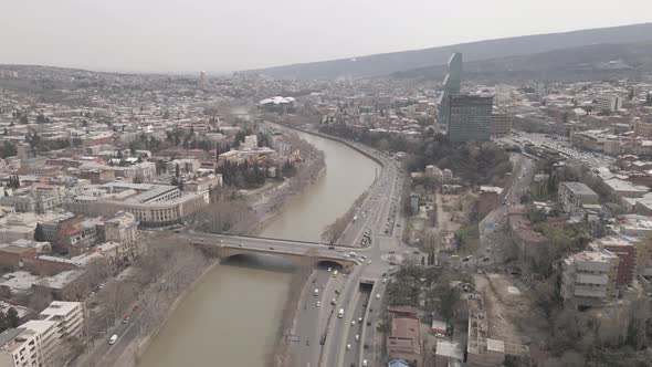 Aerial View of Galaktion Tabidze Bridge over Kura river in the centre of Tbilisi. Georgia 2021 April