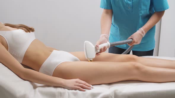 Slim Woman's Legs and Apparatus for Laser Hair Removal.
