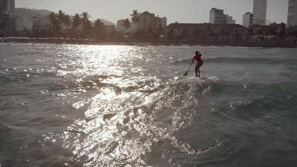 Aerial View From Above Athletic Young Women and Men Surf, Ride Big Waves with Bright Daylight