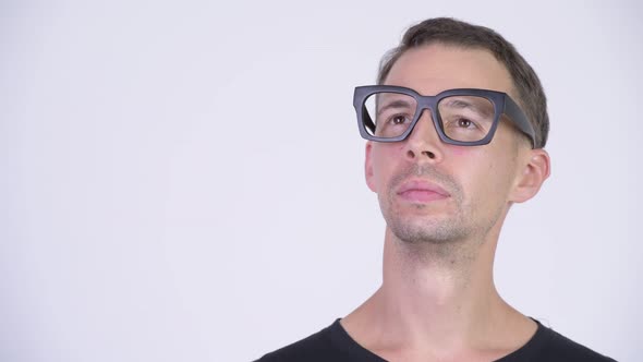 Studio Shot of Happy Nerd Man with Eyeglasses Thinking