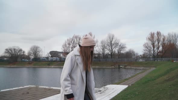 A Girl Runs Along the Embankment