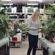 Woman Chooses Flowers in a Supermarket - VideoHive Item for Sale