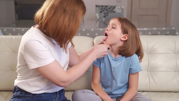the Little Girl Complains of a Sore Throat and Her Mother Examines It