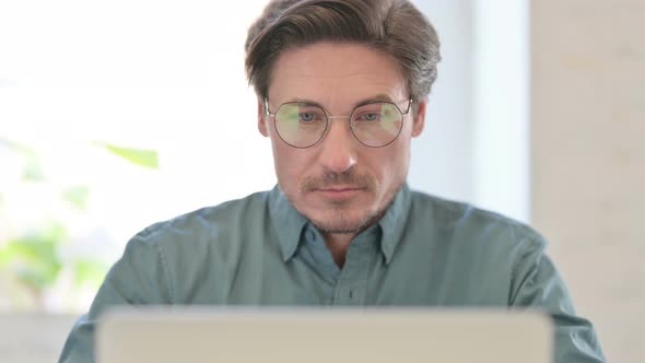 Middle Aged Man Working on Laptop, Close up