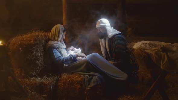 Joseph Talking with Mary and Baby Jesus in Barn