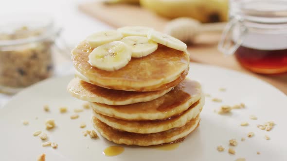 Video of pancakes on plate seen from above on wooden background