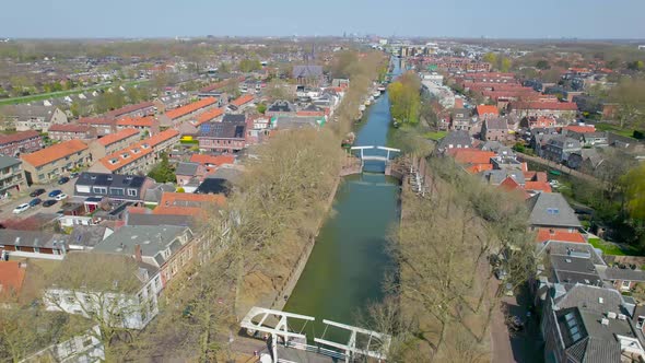 Reversing aerial reveal over canal in Vreeswijk, Utrecht