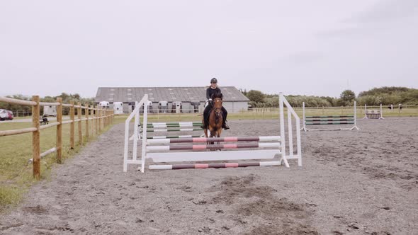 Young Woman On Horseback In Paddock