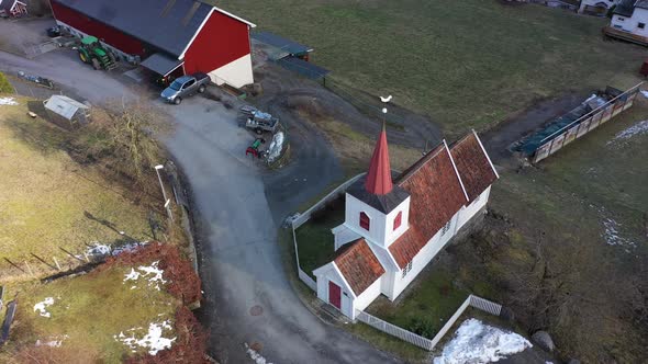 Europes smallest Stave church in Undredal Norway - Beautiful aerial rotating and descending around c