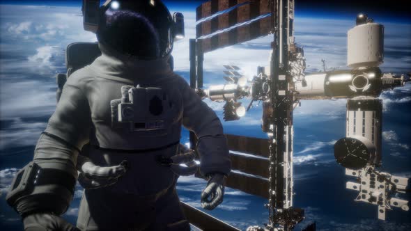 International Space Station and Astronaut in Outer Space Over the Planet Earth