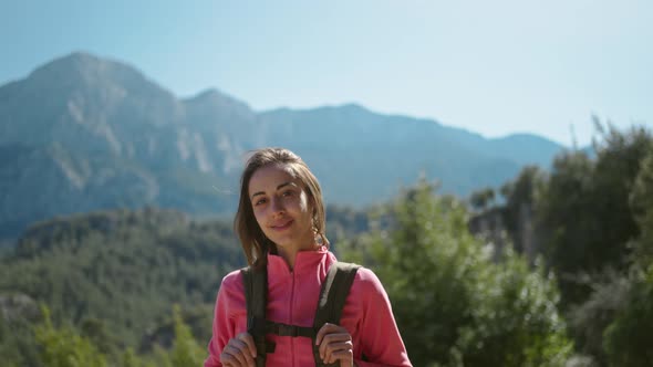 Cinematic Close Up Slow Motion of Smiling Woman Hiker Standing on Beautiful Mountain Landscape Happy
