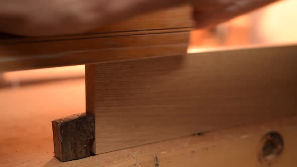 Close Up of Carpenter Planing Wood alt