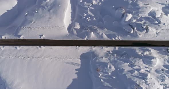 Overhead Vertical Aerial Above Snowy Road with Cars