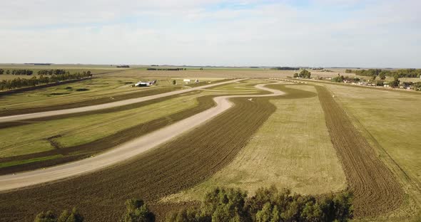 Empty Car Race Circuit in middle of a field. 4k aerial shot.