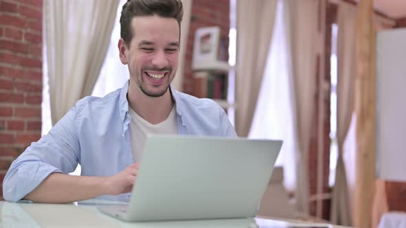 Young Man Doing Video Chat on Laptop 