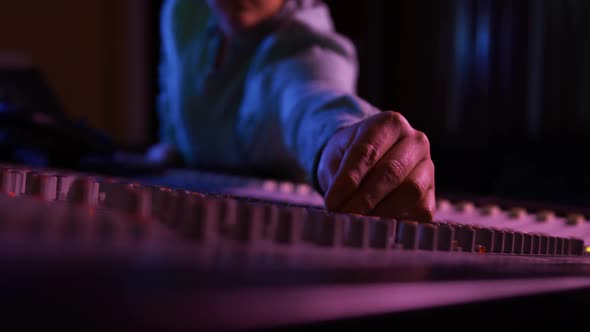 Male sound engineer working at a mixing desk