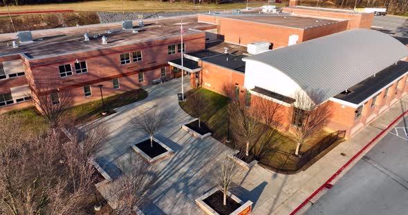 Public school building in USA. American education system. Exterior outdoor shot of brick architectur