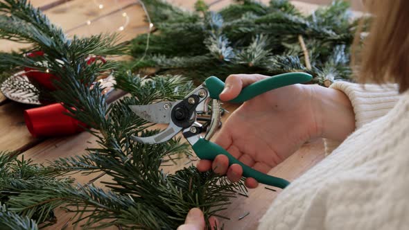 Woman Making Fir Christmas Wreath at Home