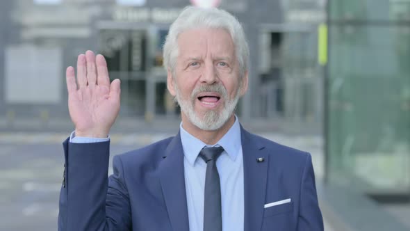 Outdoor Old Businessman Waving Welcoming