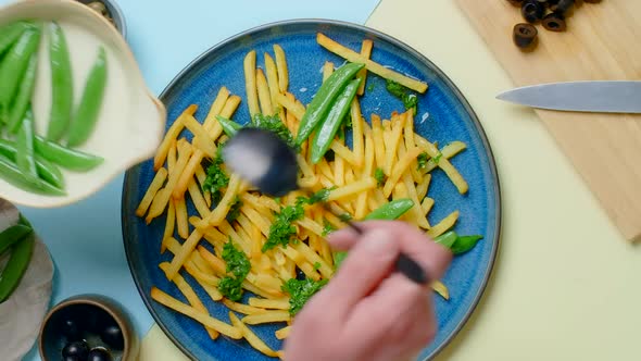 Vertical Tabletop Video Chef Adds Sweet Pea Pods to the Fried Potato Dish