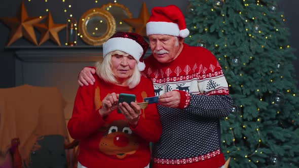 Senior Family Grandmother Grandmother Using Credit Bank Card and Smartphone Shopping Christmas Gifts