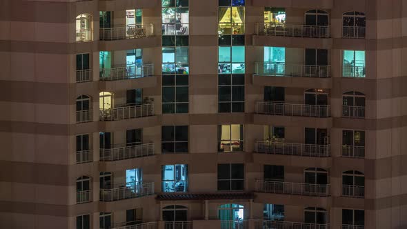 Windows of the Multistorey Building with Lighting Inside and Moving People in Apartments Timelapse