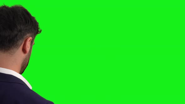 Businessman Swiping And Tapping While Standing On A Green Screen.