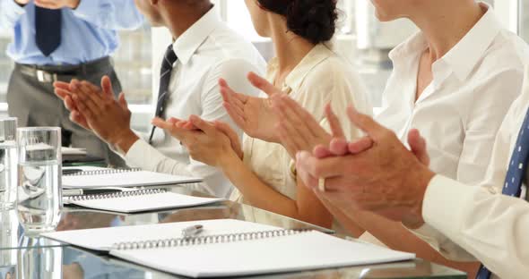 Business people clapping at presentation