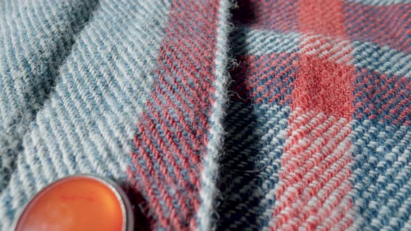 Background From a Warm Woolen Plaid Shirt with Red Buttons in Macro