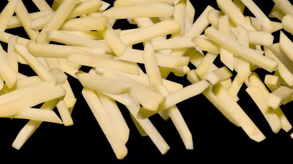 Raw French Fries In A Jump On Black