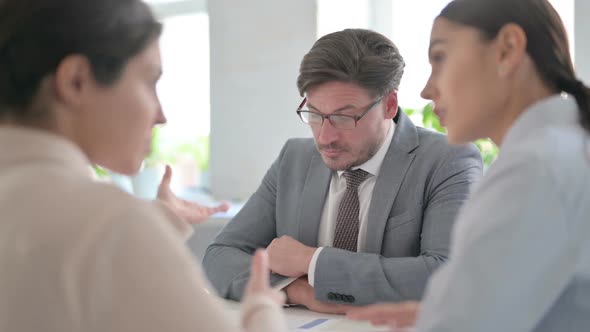 Angry Young Businesswoman Arguing with Middle Aged Businessman