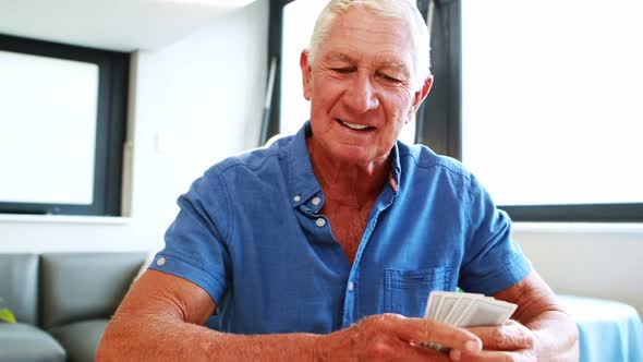 Retired man playing with cards