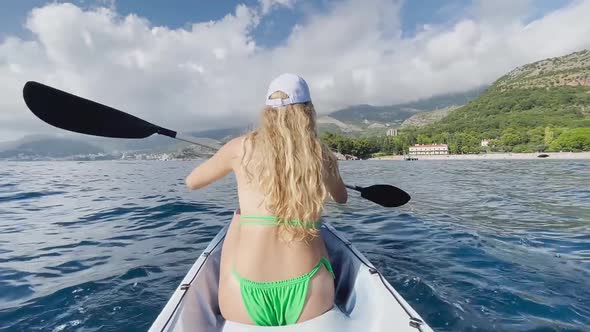 A Girl an Athlete in a Swimsuit on a Kayak Floats on the Adriatic Sea Montenegro