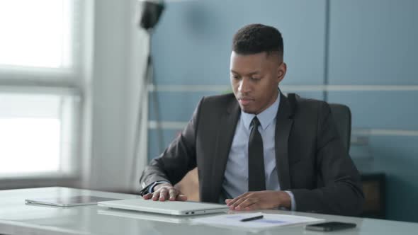 African Businessman Closing Laptop Standing Up, Going Away