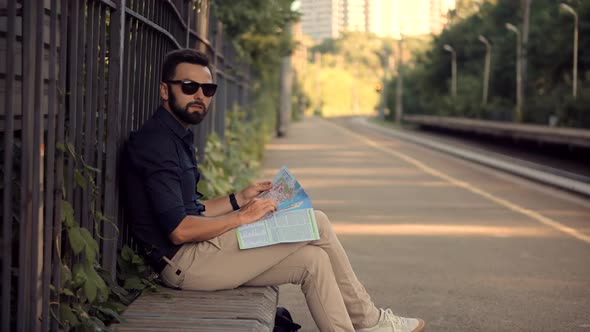 Businessman Tourist Looking On City Paper Map And Exploring City Route. Active Lifestyle On Vacation