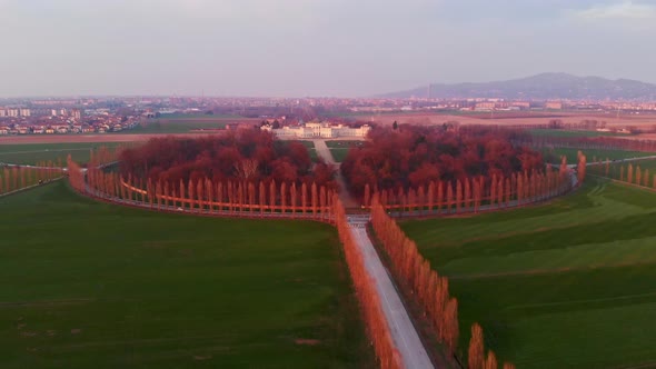 Aerial: flying over Turin countryside, road geometry from above, sunset light, Torino Piemonte Italy