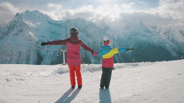 Mother and Daughter Enjoying Journey. Happy Family in Winter Clothing at the Ski Resort, Winter Time