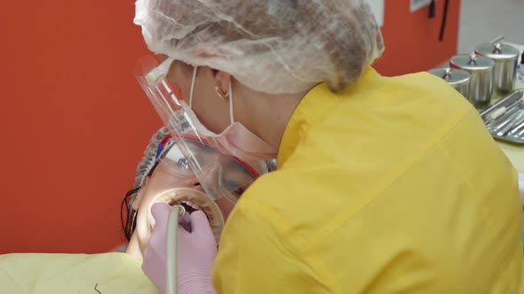 Close Up Female Hands Professional Doctor Stomatologist at Work. Person Undergoes a Medical