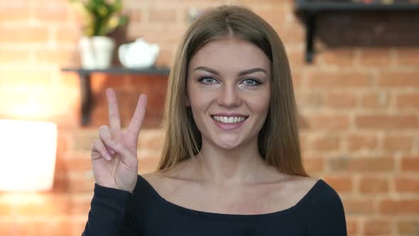 Young Girl  Showing Victory Sign, Portrait