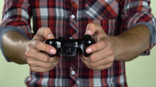 Hands of Dedicated Gamer Using a Game Controller