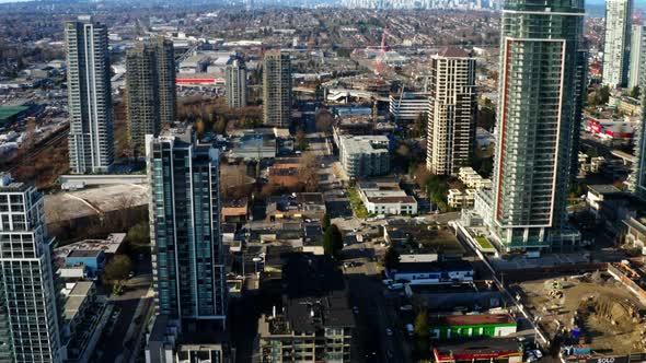 High-rise Buildings In Burnaby With Downtown Vancouver In The Background In Canada. - aerial pullbac