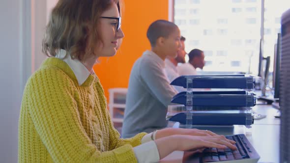 Side view of Young mixed race business team working together at desk in modern office 4k