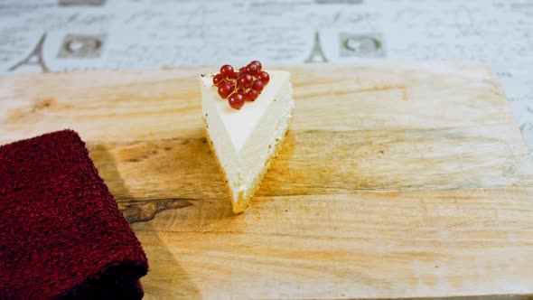 A Slice of Cheesecake Cake with a Sprig of Currant