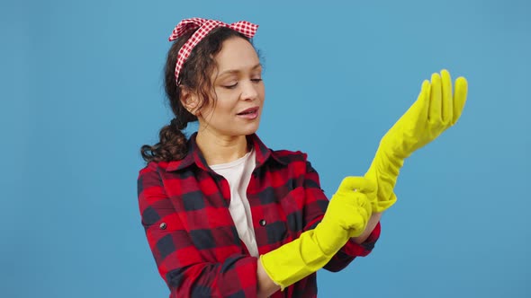 Cheerful Woman Putting on Protective Rubber Gloves and Showing OK Gesture Smiling to Camera Blue
