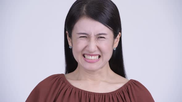 Face of Angry Asian Woman Shouting and Screaming