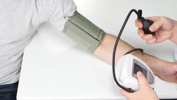 Blood Pressure Is Measured Doctor with a Tonometer. From Above