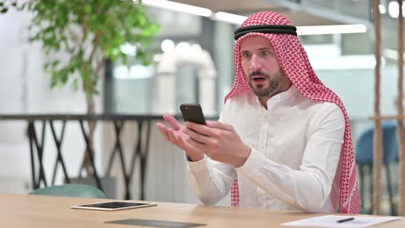 Upset Arab Businessman Having Loss on Smartphone